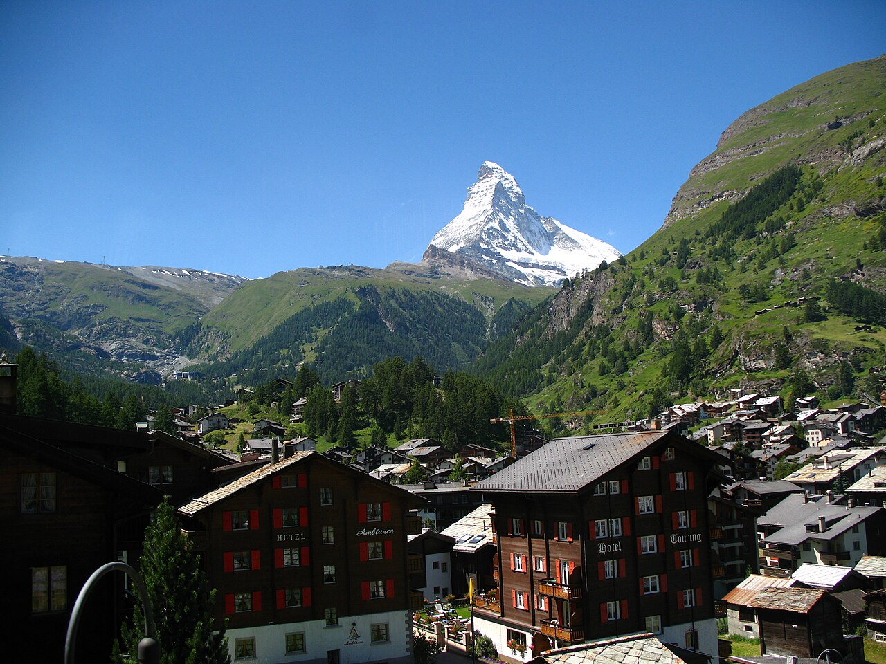 Summer Zermatt village rooftops with the Matterhorn peak in the distance