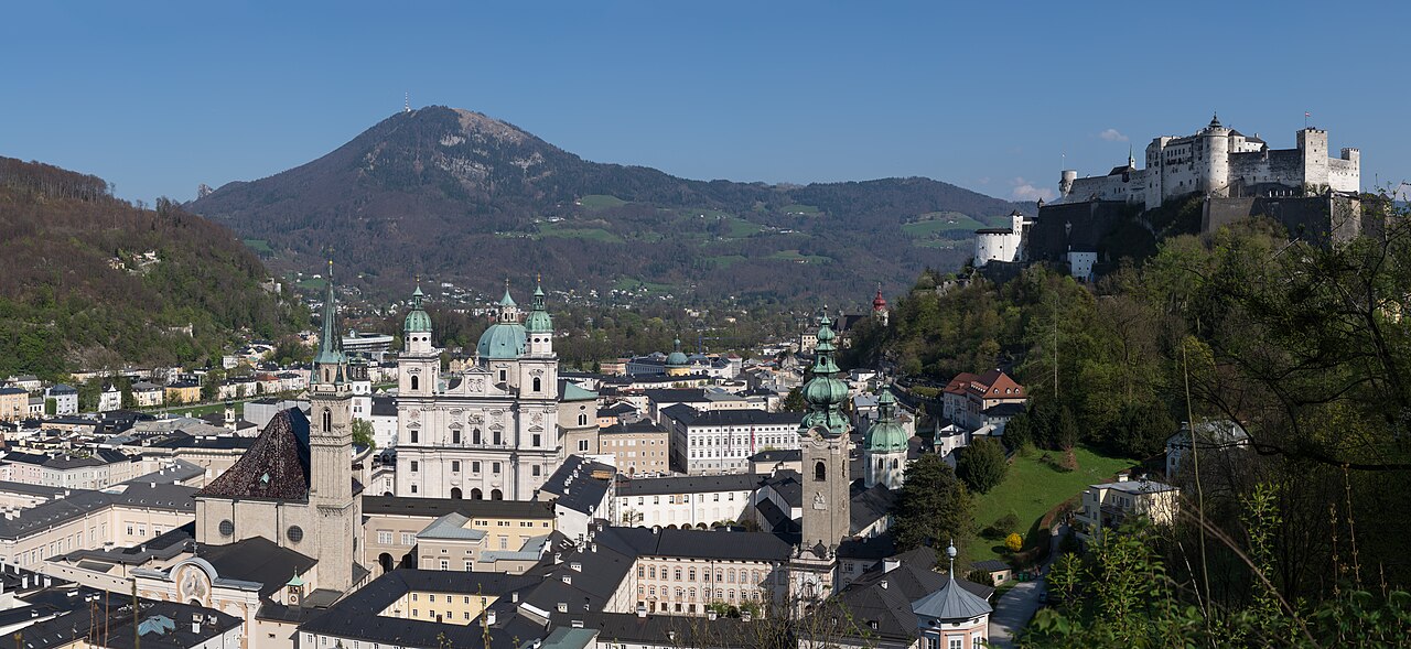 Panorama of Salzburg's old town: cathedral dome, bell towers, and Hohensalzburg Fortress on the hill