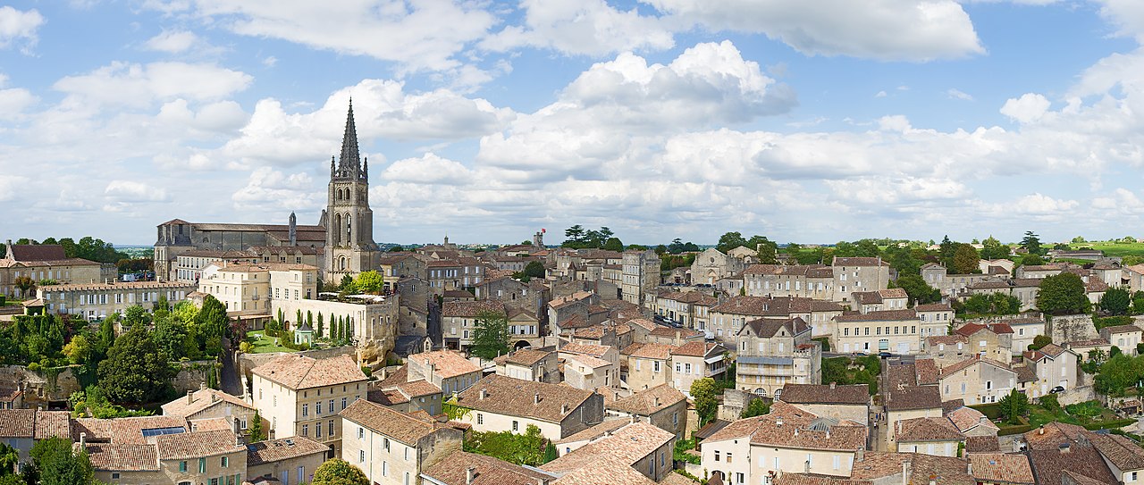 View of Saint-Émilion from the King's Tower: the spire of the Monolithic Church dominates honey-colored stone houses, and the entire village is built on a slope—the walk from the train station to the village is this uphill climb.
