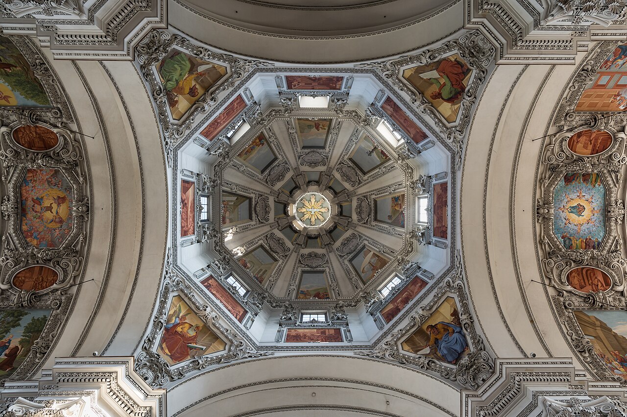 Interior view of Salzburg Cathedral dome from below, with Baroque frescoes and octagonal skylights