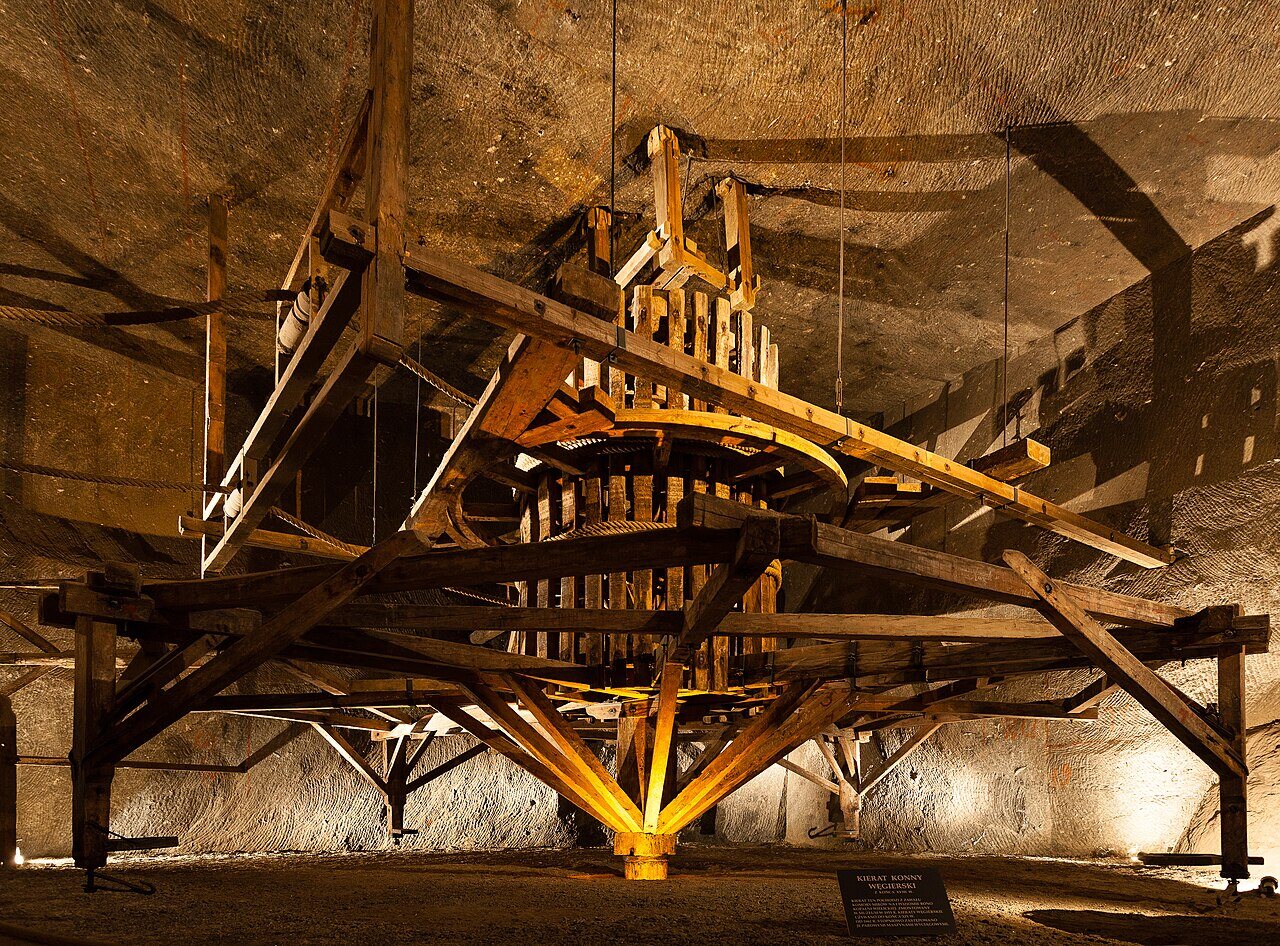 Large wooden horse-powered winch mechanism in an underground chamber of the Wieliczka Salt Mine