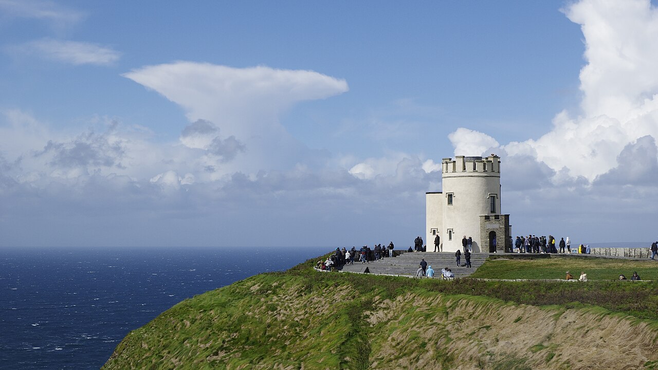 O'Brien's Tower observation deck at the Cliffs of Moher, with steps and platform crowded with tourists