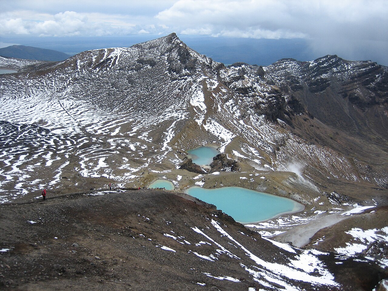 Volcanic terrain and snow patches around the Emerald Lakes on Tongariro Alpine Crossing