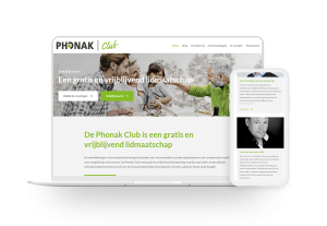 Laptop en telefoon met daarop de website van Phonak Club