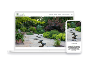 Laptop en telefoon met daarop de website van Tuinontwerp 24
