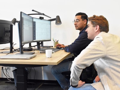 Two PrismaFleet employees looking at a computer screen together