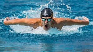 Man coming out of the water doing a butterfly stroke
