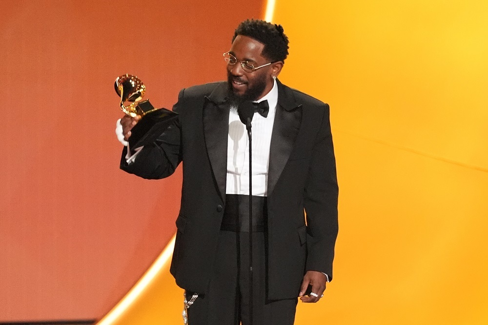 Kendrick Lamar poses triumphantly, surrounded by imagery symbolizing his reign as the undisputed king of hip-hop.