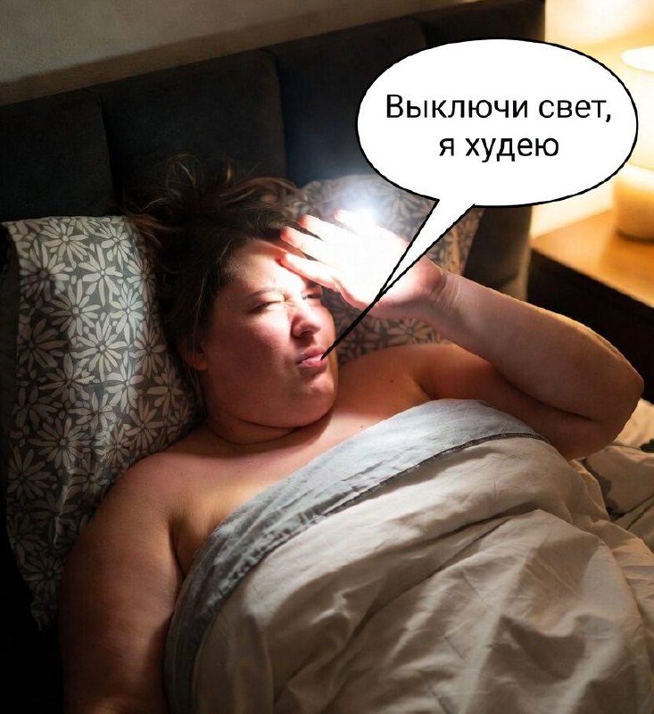 Человек спит перед включенным телевизором, на тумбочке рядом лежит упаковка от чипсов