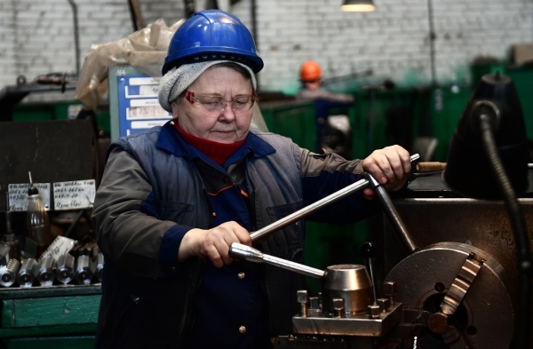 Женщина управляет бульдозером, символизируя новые горизонты для женщин в строительной сфере.
