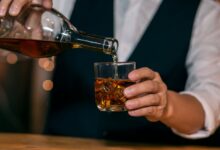 Тульский самовар с бутылкой шотландского виски на фоне пряников