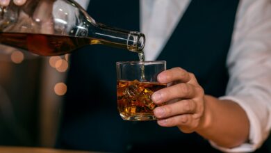 Тульский самовар с бутылкой шотландского виски на фоне пряников