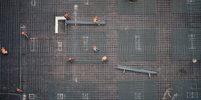 A top down view showing construction workers laying rebar