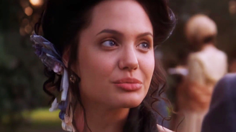 Юная Анджелина Джоли в костюме ковбоя на фоне пейзажа Дикого Запада.