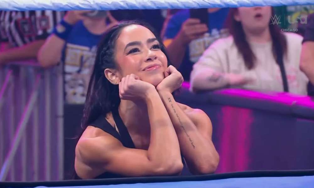 AJ Lee and Bayley in a wrestling ring, facing each other intensely.