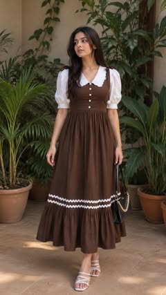 Instagram Reel by @sakshu_eraa, published May 16, 2026. ✨ Follow + comment for 'Link' ?? . . Vintage-inspired brown midi dress with a soft white puff-sleeve co…