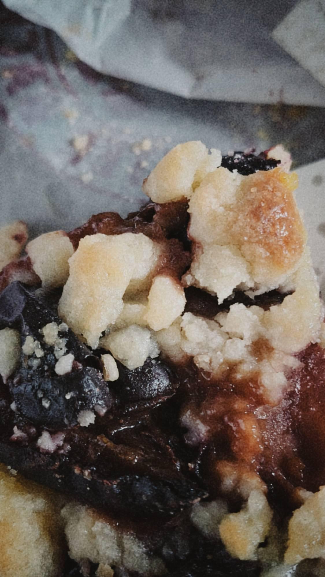 Closeup of a piece of plum pie.