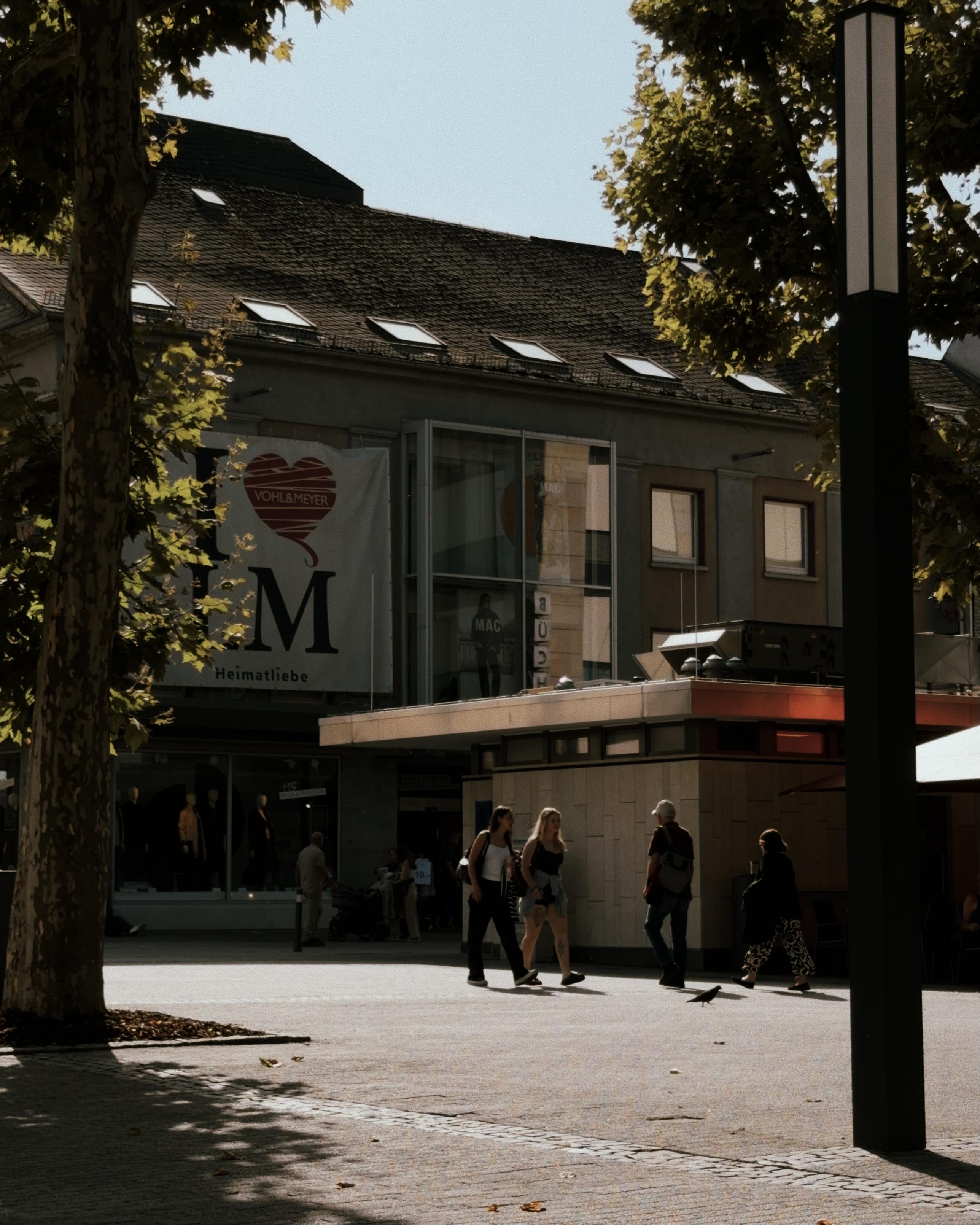 People walking through a sunny town