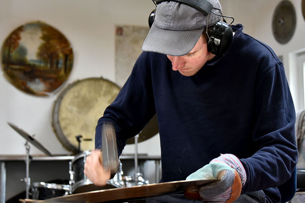 Jesse Simpson at Ateliér 57 making cymbals